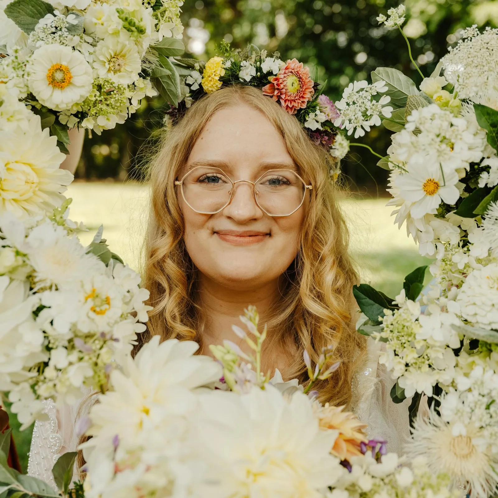 A bride with a flower crown surrounded by white blooms